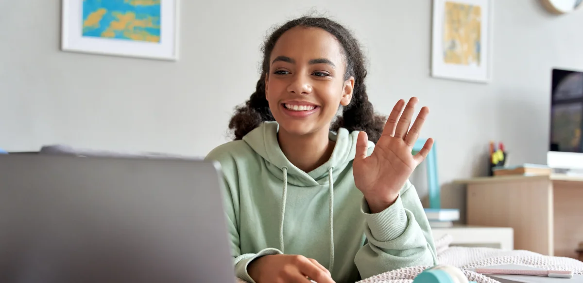 Girl waiving at her online class